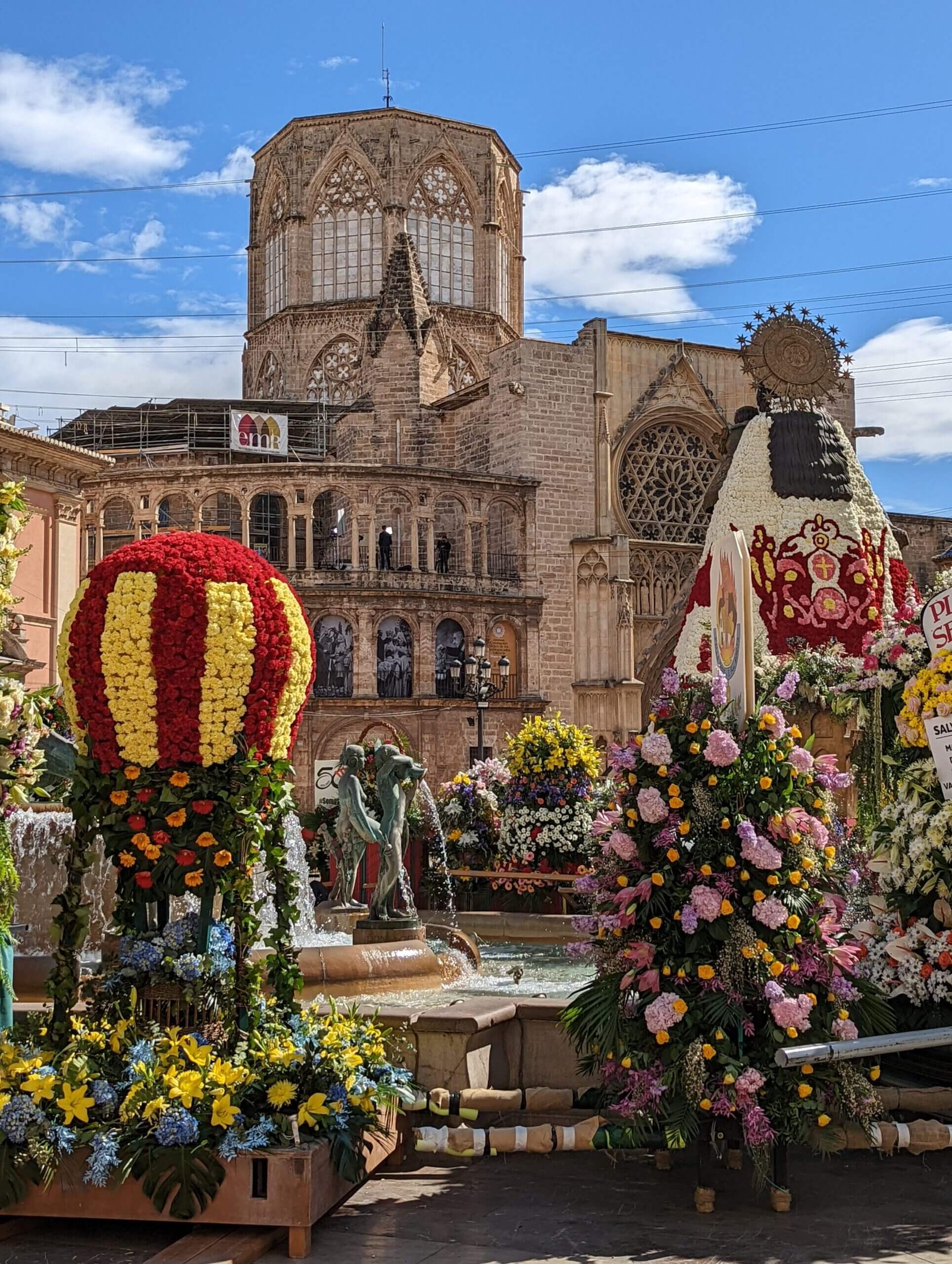 The Plaça de la Mare de Deu dels Desemparats in March during Les Falles, filled with ornate flower offerings