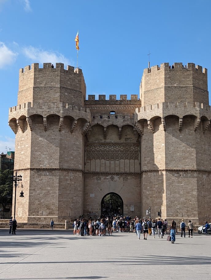 Stone towers of Torres dels Serrans with visitors climbing to the top