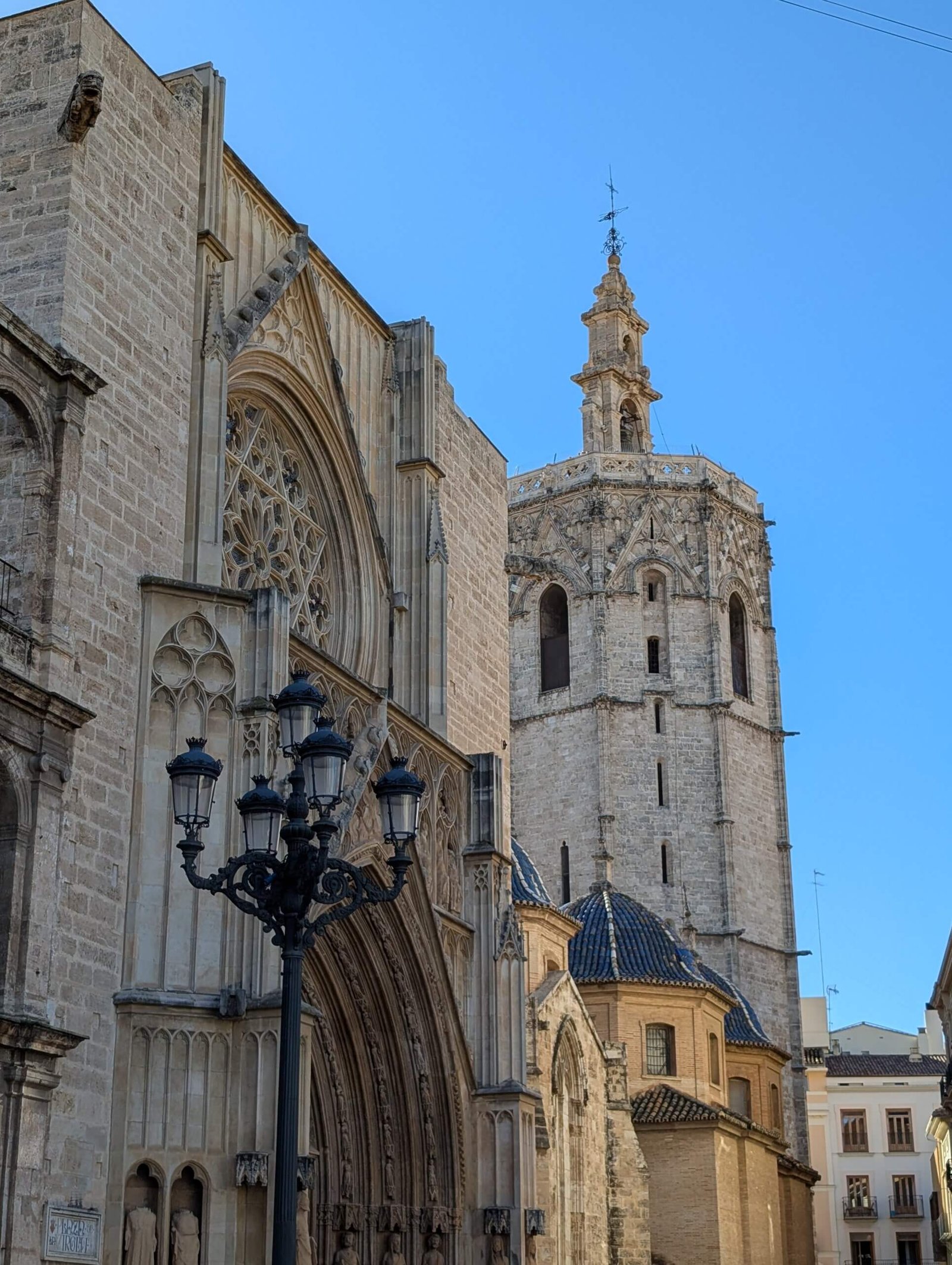 View of Valencia Cathedral and the El Miguelete bell tower under a clear blue sky